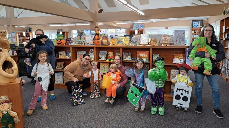 Children in library dressed in Halloween costumes