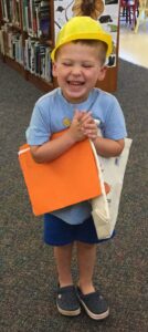 Boy receiving 1,000 Books by Kindergarten recognition