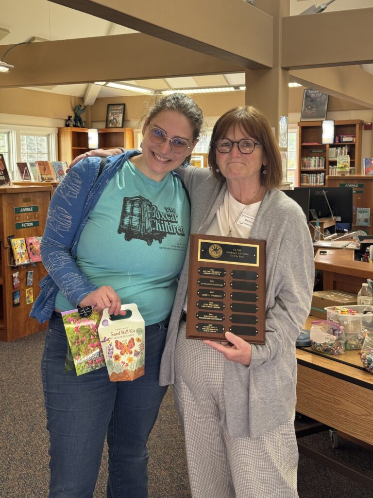 Sharon Gulla receives the NH Children's Librarian of the Year Award from Nicole Gavreau, the Childrens Librarians of NH President, at the library on April 24, 2026.