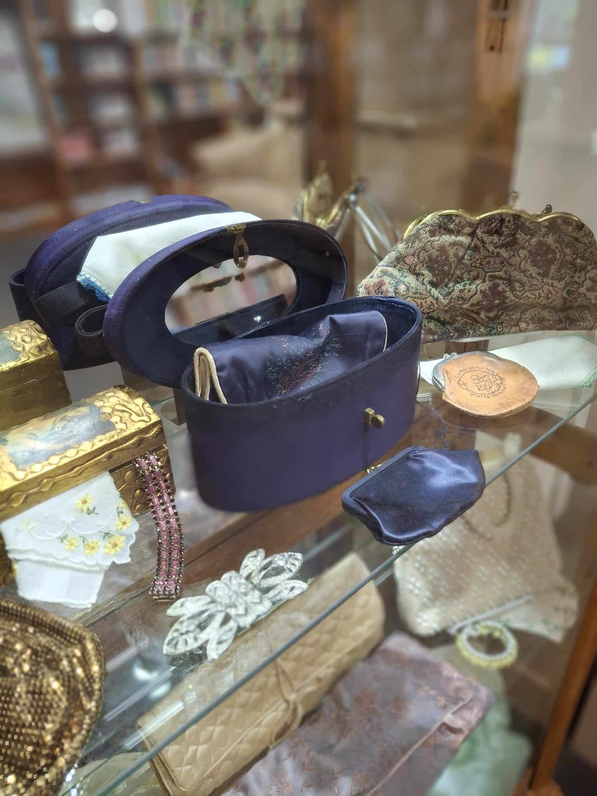 Collection of vintage purses displayed in the library's glass case.